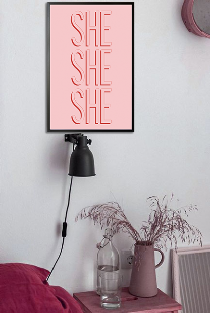 SHE poster in black frame