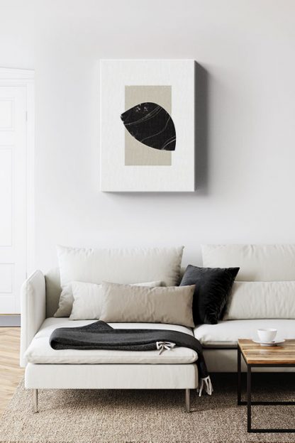 Black object on neutral color rectangle canvas in interior