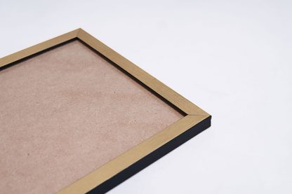 A gold frame with cardboard in a close up view