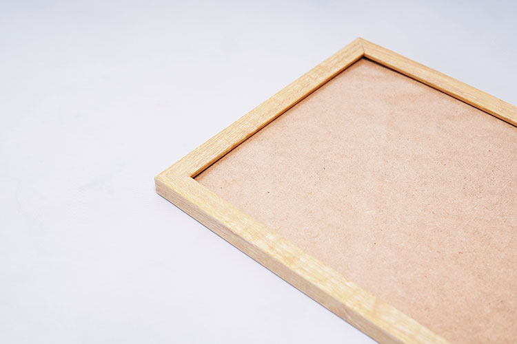 A wood frame with cardboard in a close-up view