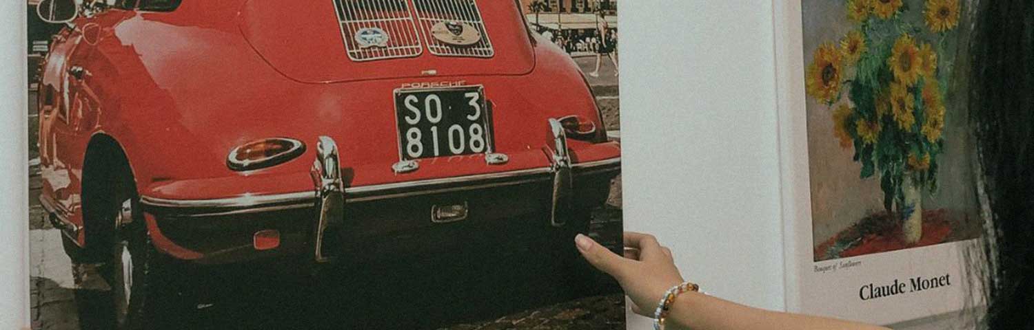 A red vintage car printed on a canvas paper.